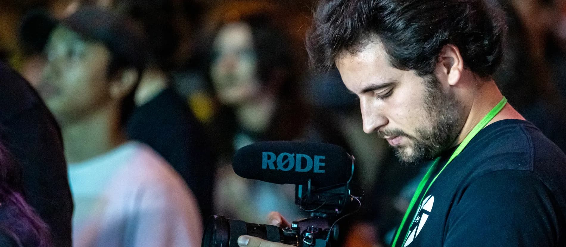 Caleb Kolstad filming in the middle of a night crowd at a live worship event
